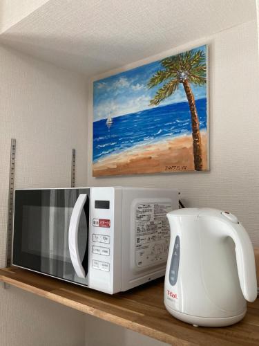 a microwave and a coffee maker on a shelf at Tokyo Disney Resort 3 minutes by train, along Symbol Road, and plenty of commercial facilities!Free wifi, double bed in Tokyo