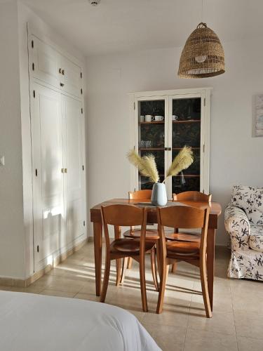 a dining room with a table and two chairs at Hispalis Mazagón Beach 305 in Mazagón