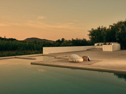 a pool of water next to a patio at Drallos Luxury Villa - Private Heated Pool & Large Groups, by ZanteWize in Alikanas