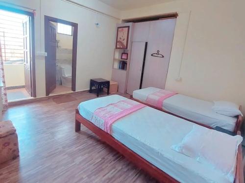 Кровать или кровати в номере GIFTLAND HOMESTAY