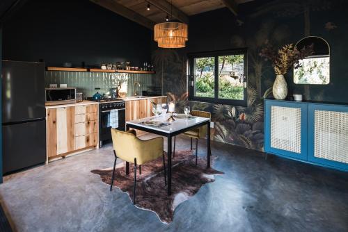 a kitchen with a table and chairs in it at Bains View Olive and Guest Farm in Wellington