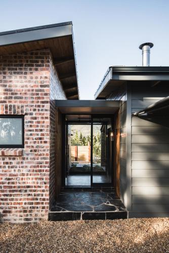 a brick house with a glass door entrance at Bains View Olive and Guest Farm in Wellington