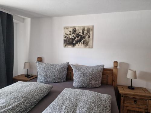 a bedroom with two beds and a painting on the wall at Ferienwohnung Alpenhirsch Schwangau in Schwangau
