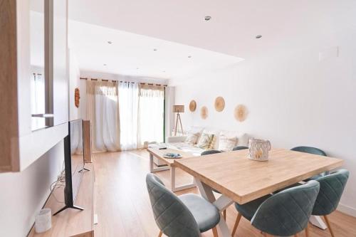 a living room with a table and chairs and a couch at Lovely Duplex with Beatiful views in Panticosa in Panticosa