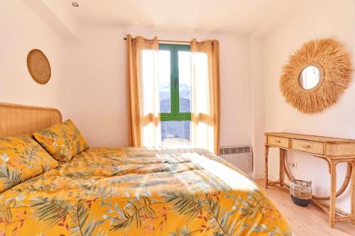 a bedroom with a bed and a table and a window at Lovely Duplex with Beatiful views in Panticosa in Panticosa