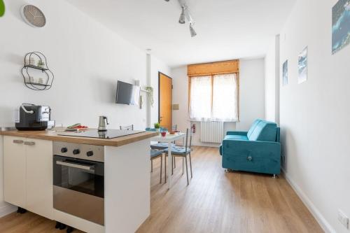 a kitchen with a counter and a table in a room at Casa Francesca - Cisanello in Pisa
