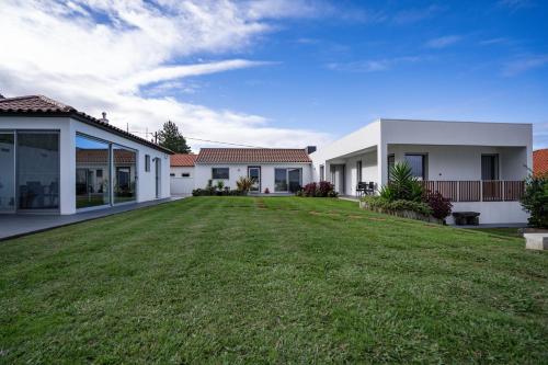 a large yard in front of two houses at Serenity Azores - Casa da Aldeia in Nordestinho