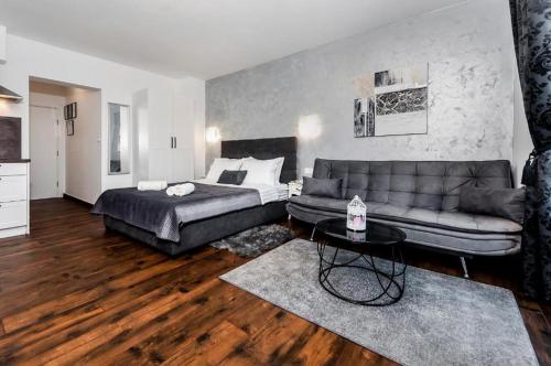 a living room with a bed and a couch at Deluxe Apartments A&A - 2 in Rovinj