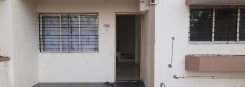 an open door of a white building with windows at Swanky Midtown Holiday Inn 2BHK in Kolhapur