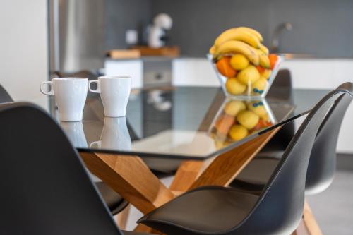 a glass table with a bowl of fruit on it at Buena - Vista in La Guancha