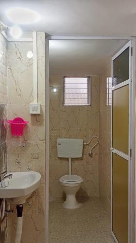 a bathroom with a toilet and a sink at Radha Krishna Villa in Belkāde