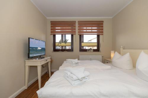 Postel nebo postele na pokoji v ubytování Urlaubstraeume-am-Meer-Wohnung-5-6-656