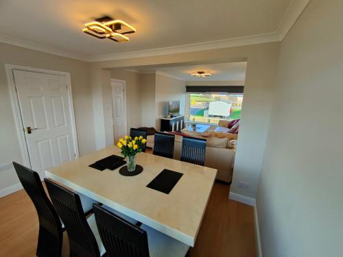 a dining room and living room with a table and chairs at Hyecliffe House in Whitby