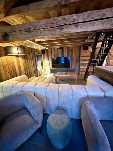 a large living room with couches and a flat screen tv at Chalet Jean (Coeur de Morzine) Jacuzzi & Sauna in Morzine