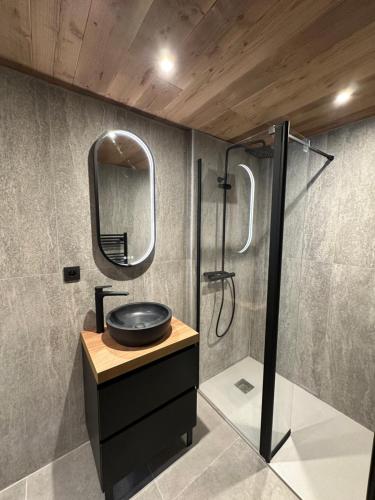 a bathroom with a sink and a shower at Chalet Jean (Coeur de Morzine) Jacuzzi & Sauna in Morzine
