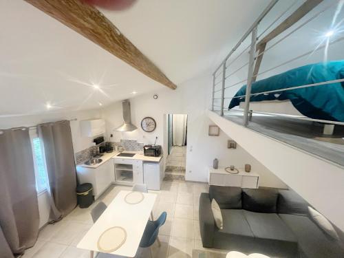 a kitchen and a living room with a staircase at A deux pas des péniches in Castelsarrasin