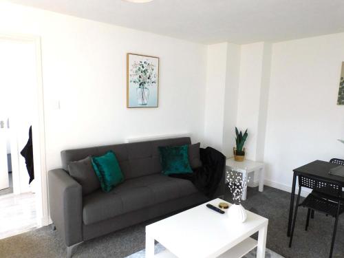 イースト・キルブライドにある4 Bedroom Newly Refurbished Home in East Kilbrideのソファとテーブルのあるリビングルーム