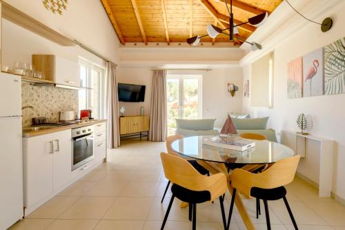 a kitchen and dining room with a table and chairs at ALMA HILLS Gialova in Gialova