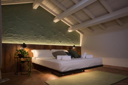 a bedroom with a large bed in a room at Cà Toresele Relais Osteria Garden in Verona