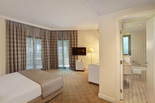 a hotel room with a bed and a bathroom at Le Royal Hotel - Beirut in Beirut