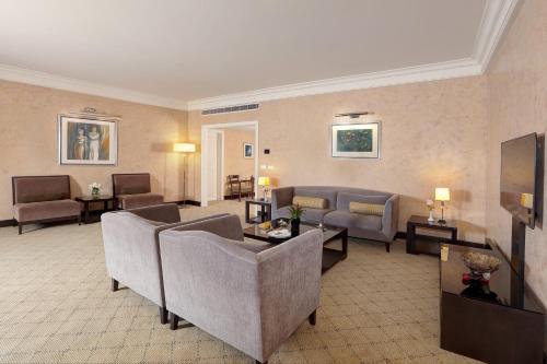 a living room with couches and a couch and tables at Le Royal Hotel - Beirut in Beirut