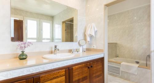 a bathroom with a sink and a mirror and a tub at Ca Nostra in Son Servera