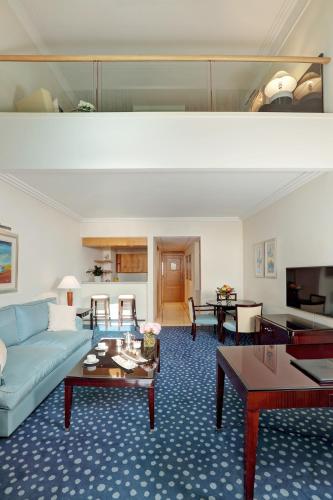 a living room with a couch and a table at Le Royal Hotel - Beirut in Beirut
