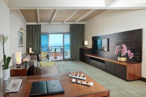a living room with a television and a couch at Le Royal Hotel - Beirut in Beirut