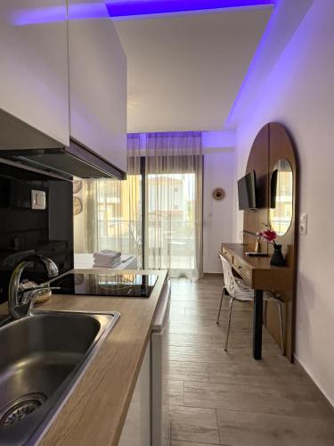 a kitchen with a sink and a counter top at Bamboo Luxury Studios in Nikiti