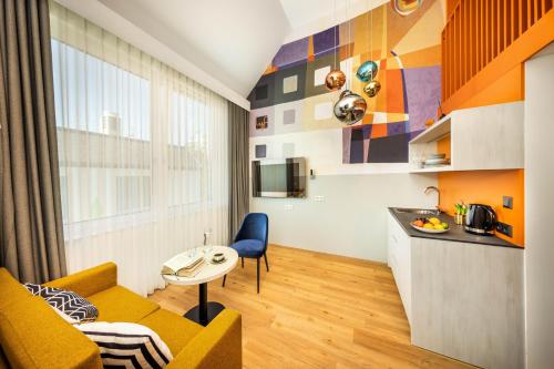 a kitchen and a living room with a couch and a table at lyf Schönbrunn Vienna in Vienna