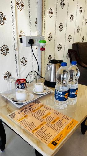 a table with drinks and water bottles on it at Unity Sunrise Resort Best Hotel Near Statue of Unity in Kevadia