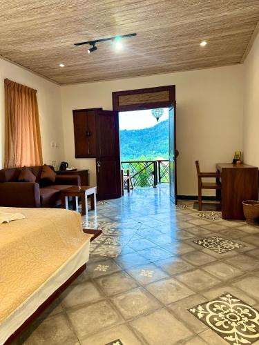 a bedroom with a bed and a living room at Villa Karma Loka in Sidemen
