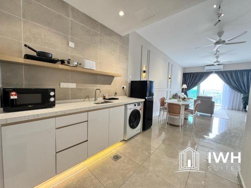 a kitchen with a sink and a stove at ICC Ipoh Town Premium Suites By IWH Suites in Ipoh