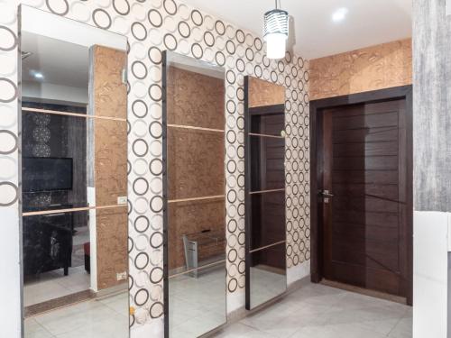 a room with mirrored doors and a wall of mirrors at Family Comfort Suites in Rawalpindi