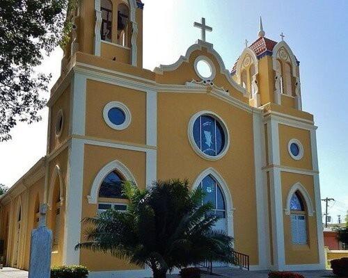 a church with a clock on top of it at West Side Studio Apartments in Anasco