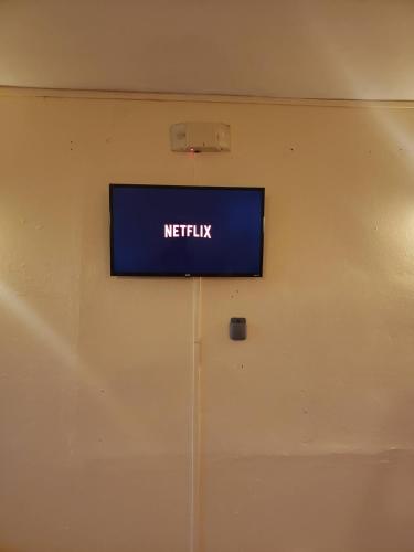 a sign on a wall above a door at West Side Studio Apartments in Anasco