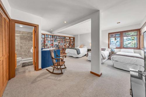 a bedroom with two beds and a chair in a room at Pet-Friendly Home, Deck, 1 Mile to Alpine Meadows in Alpine Meadows