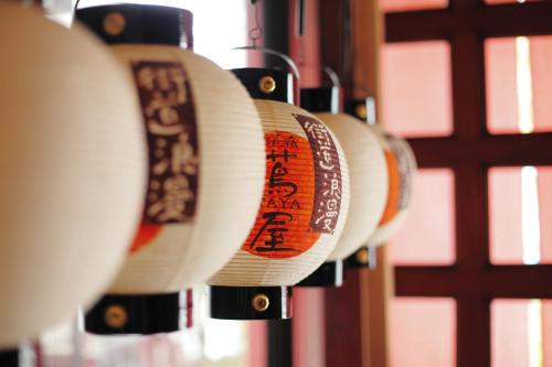 a row of paper plates hanging on a wall at Onyado Tsutaya in Kiso