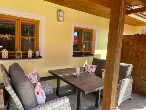 a dining room with a wooden table and chairs at Landhaus Constantin Luxus-Appartments in Berchtesgaden