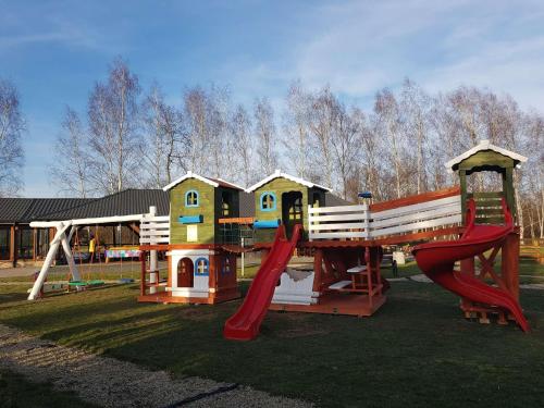 a park with a playground with a slide and a swing at Hotel Karpik Zator Graboszyce in Graboszyce