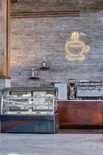 a coffee shop with a sign on a brick wall at Pearl Continental Hotel, Muzaffarabad in Muzaffarabad