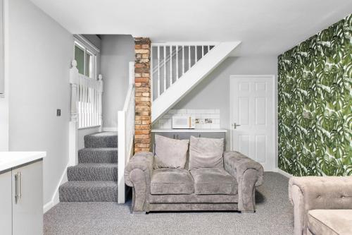 a living room with a chair and a staircase at Still House in Boston