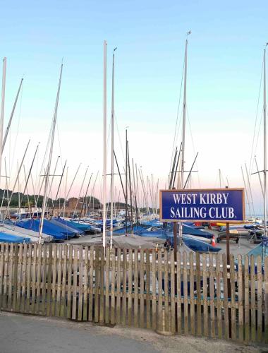 a bunch of boats parked in a marina with a sign at 2025 Traveller award winner Just bring clothes in West Kirby