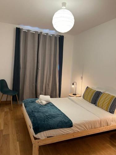 a bedroom with a large bed with a blue blanket at Ramona in Aveiro