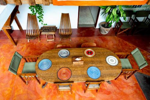 an overhead view of a wooden table and chairs at The River Villa Situated In A Lush Garden in Arusha