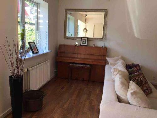 a living room with a white couch and a mirror at Dream house with lake view, 20 min near Copenhagen in Virum
