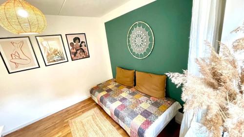 a bedroom with a couch in a room with green walls at Dream house with lake view, 20 min near Copenhagen in Virum