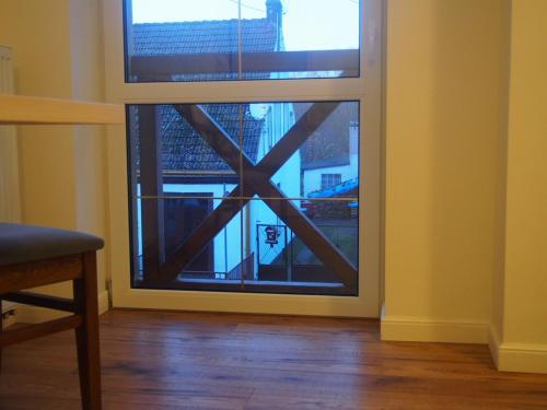 a glass door with a view of a building at Tawerna Panorama in Stepnica