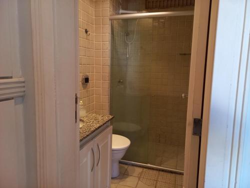 ein Badezimmer mit Toilette und Glasdusche in der Unterkunft apartamento em aréa nobre in Vitória da Conquista