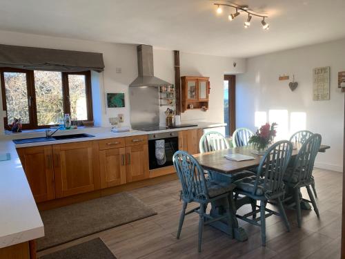 a kitchen with a table and chairs in a kitchen at Edge Barn in Woolaston